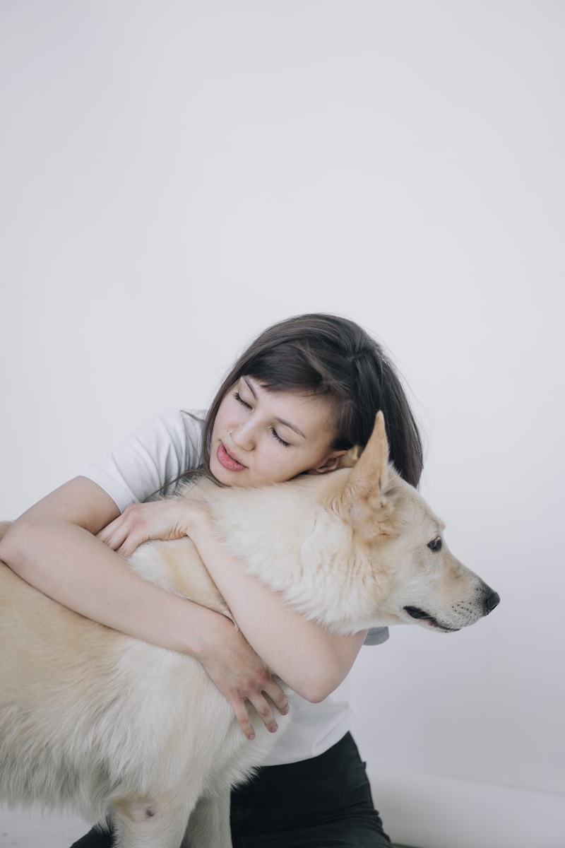 Photo by Sasha Sashina woman hugging a dog